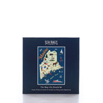 A navy blue box containing the Galleyware Maine Landmarks Jigsaw Puzzle, a 1000-piece puzzle featuring an illustrated map of Maine with nautical and regional icons, crafted using recycled materials. by Sea Bags