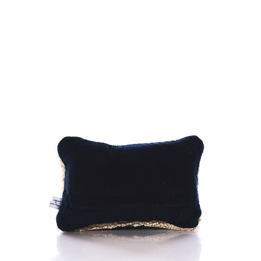 A small rectangular Chandler 4 Corners Wool Hand-hooked Maine Pillow in black, featuring light-colored textured edges, is centered on a white background, highlighting the cozy, handcrafted quality of this artisan wool pillow. by Sea Bags