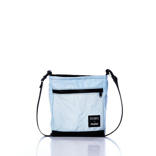 Vintage Light Blue Small Voyager Crew Crossbody by Sea Bags, featuring a black adjustable strap, front zippered pocket, and a SEA BAGS logo patch, crafted from recycled sail cloth for a durable and sustainable design, displayed on a white background. by Sea Bags